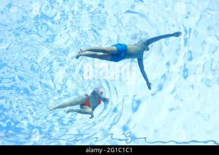 London, UK. Swimmers enjoy a dip in the newly opened transparent Sky Pool which is suspended between two buildings 115ft up in the air. Stock Photo