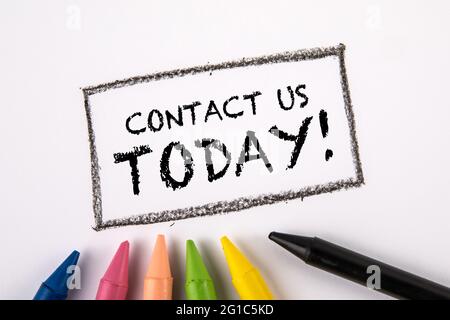 CONTACT US TODAY. Colored pastels on a white sheet of paper. Stock Photo