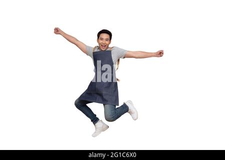 Startup successful small business owner man sme jumping isolated on white background, Asian man barista cafe local owner of coffee shop restaurant Stock Photo