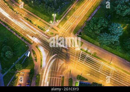 road intersection with car traffic at night city. aerial photography. Stock Photo