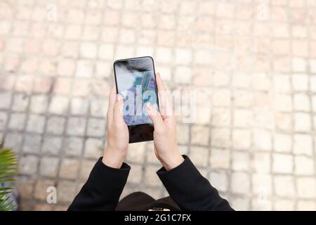 Hands of woman checking map via mobile application when setting destination point Stock Photo
