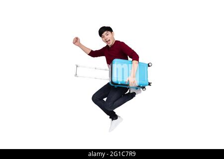 Young Asian man jumping with suitcase travel bag isolated on white background Stock Photo