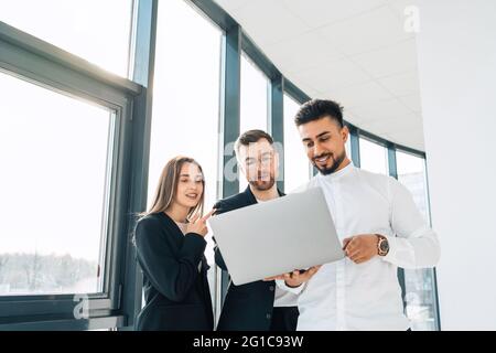 Two office workers show their new project to the boss Stock Photo