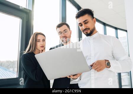 Group of software developers is thinking about  new project Stock Photo