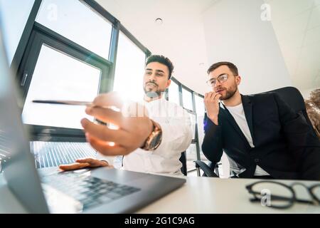 Two businessmen working on laptop on new project Stock Photo