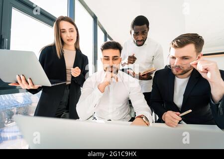 Multiracial team of programmers working together on a new assignment Stock Photo