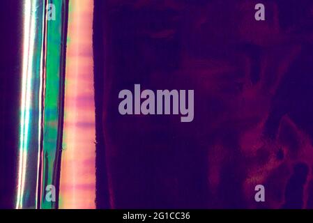 Holographic abstract multicolored background. Vibrant purple color, futuristic retro style. Stock Photo