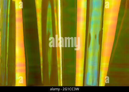 Holographic multicolored striped background. Vibrant green and yellow colors, futuristic retro style. Stock Photo