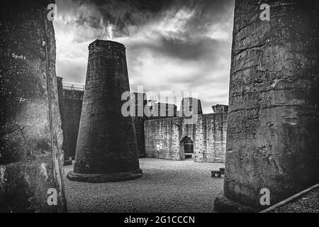 Ironworks in the Ruhr area in dramatic weather. Steelworks, colliery and blast furnace in the Ruhrpott in the evening sun in the landscape park. Stock Photo