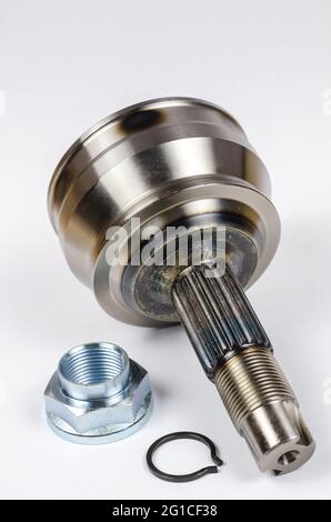 Set Drive shaft joint on white background. New Constant velocity joints, hub nut and retaining ring. The constant velocity joint provides torque trans Stock Photo