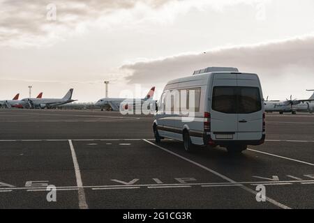 Minibus on a parking lot in airport Stock Photo