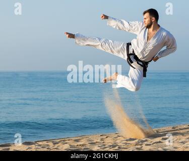 young man practicing karate positions Stock Photo