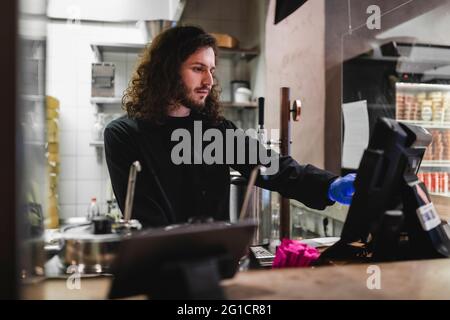 Male chef working on computer in restaurant Stock Photo