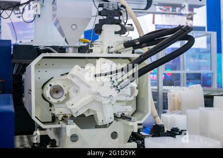 Part of automatic plastic injection molding machine during work Stock Photo