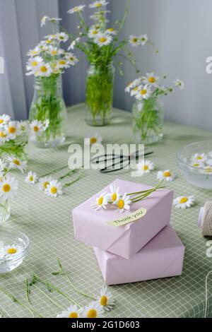 Gift decorated with chamomile flowers with words of gratitude. High quality photo Stock Photo