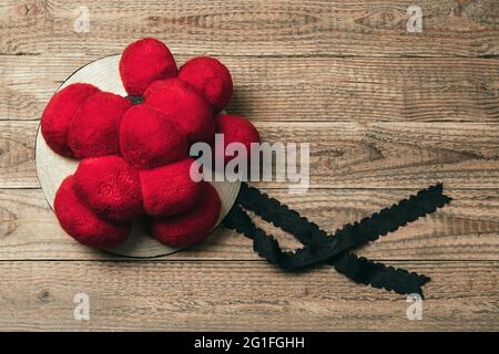 Original Black Forest Bollen hat on rustic wooden background, Germany Stock Photo