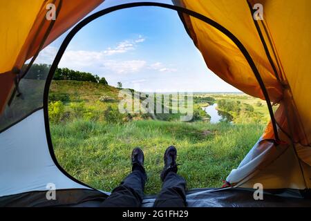 View from inside a tent on beautiful summer landscape Stock Photo