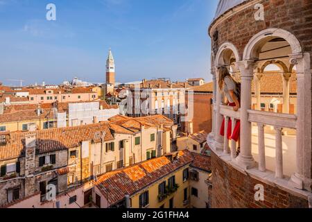 Young woman, tourist looking over Venice, dome of Palazzo Contarini del Bovolo, palace with spiral staircase, Venice, Veneto, Italy Stock Photo