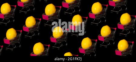 Lemons in shopping trolleys, creative pattern background of lemons in shopping trolleys, isolated on black, banner. Stock Photo