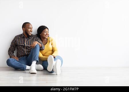 Happy young couple sitting near swimming pool Stock Photo - Alamy