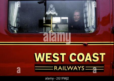 West Coast Express, 1st class, passenger, woman looking out of window, Jacobite Express, steam locomotive, railway, train, West Highland Line Stock Photo