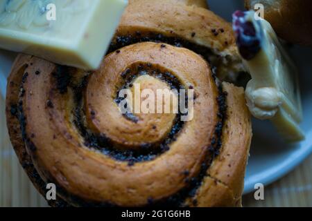 Poppy seeds bun with chocolate slices. Dessert on the plate. Delicious food Stock Photo