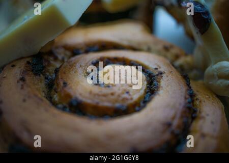 Poppy seeds bun with chocolate. Dessert on the plate. Delicious food Stock Photo