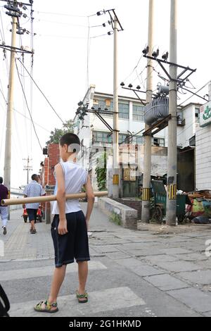 Boy in Street Life on the streets of Doncheng District in Beijing, Peoples Republic of China. Stock Photo