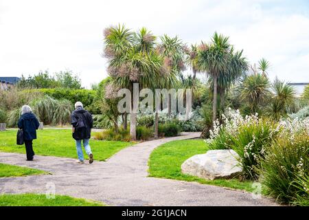 Pool,Cornwall,7th June 2021,Two people walking through the Diaspora Gardens in Heartlands, Cornish Heritage & Culture site in Pool. The glorious sunshine is forecast to continue tomorrow with a temperature of 17C.Credit: Keith Larby/Alamy Live News Stock Photo