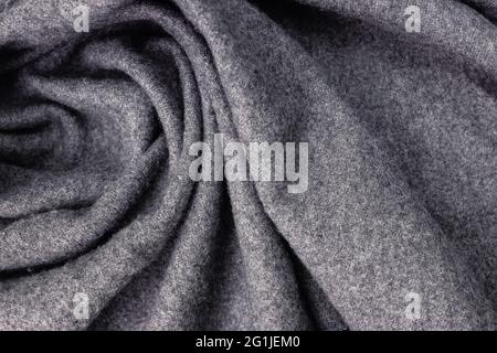 Grey woolen cozy scarf texture close-up. Stock Photo