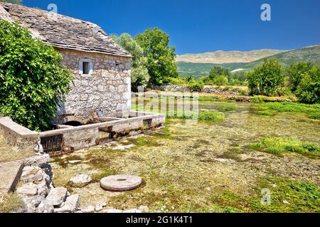 Old stone mill ruins on Cetina river source, Dalmatian Zagora region of Croatia Stock Photo