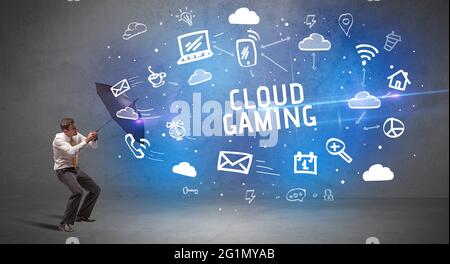 Businessman defending with umbrella, modern technology concept Stock Photo