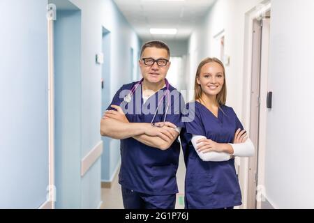 Two doctors discussing diagnosis while walking Stock Photo