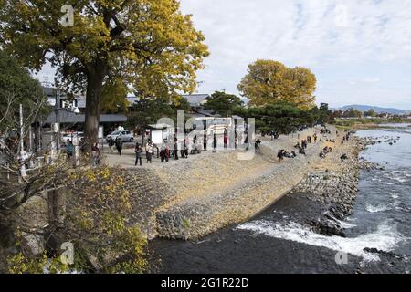 KYOTO, JAPAN - Dec 11, 2019: Kyoto, Japan-26 Nov, 2019: Tourists on the Katsura Riverbank near Togetsu Bridge in Kyoto, Japan. Stock Photo