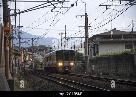 KYOTO, JAPAN - Dec 11, 2019: Kyoto, Japan-26 Nov, 2019: Sagano local train pass through Arashiyama in the autumn. Stock Photo