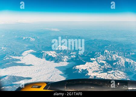 Aerial View From Airplane Window On Snowy Top Of Tatra Mountains In Summer Day. High Attitude. Stock Photo