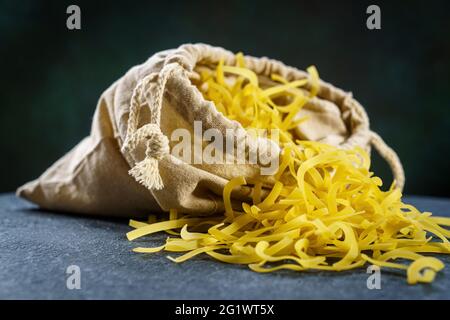 Homemade dry pasta in bag close-up, selective focus Stock Photo