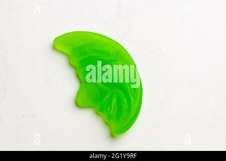 Green moon-shaped marmalade isolated on a white background Stock Photo