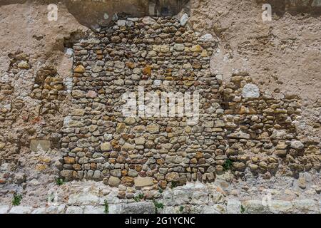 Old random stone side wall of abbey church of Saint Pierre, Beaulieu-lès-Loches, Indre-et-Loire (37), France. Stock Photo