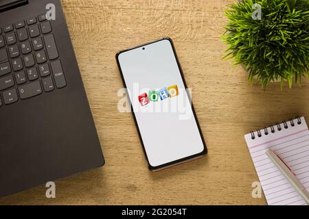 Assam, india - May 29, 2021 : Zoho logo on phone screen stock image. Stock Photo