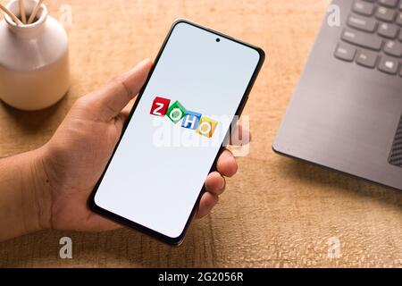 Assam, india - May 29, 2021 : Zoho logo on phone screen stock image. Stock Photo