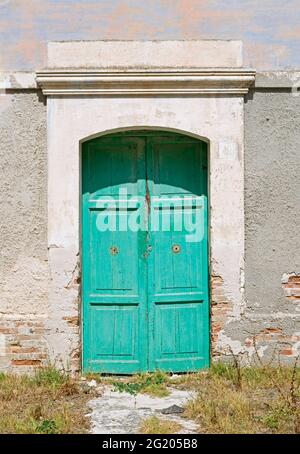 green door of an abandoned old building Stock Photo