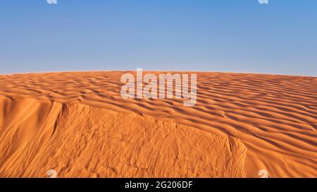 wind blowing sand over a sand dune in San Rafael Swell area in Utah Stock Photo