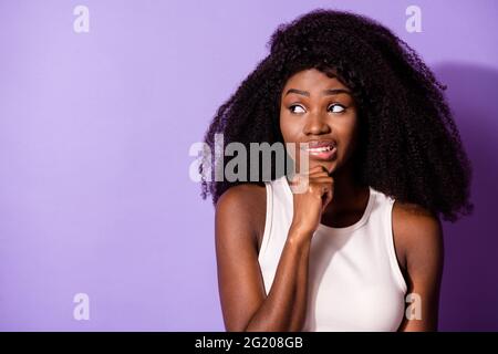 Portrait of attractive worried girl creating solution copy space overthinking isolated over bright violet purple color background Stock Photo