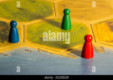 Three different colored chips on game board Stock Photo