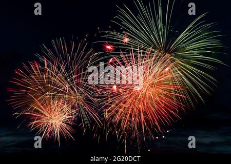Bright colored fireworks on a black background. Celebration and holidays concept. New Year, Independence Day, July 4 Festival. Bright explosions of li Stock Photo