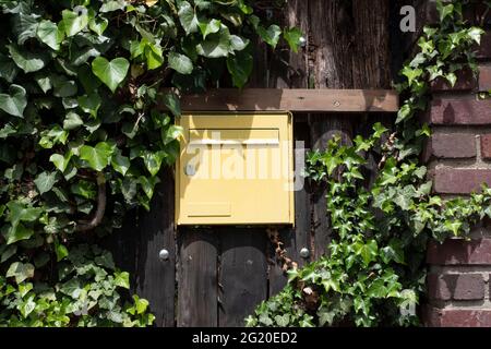 Close-up of an old mailbox on the outside wall of a house Stock Photo