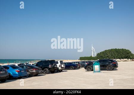 Cars parked on one of the few public beaches in Dubai, UAE. Stock Photo