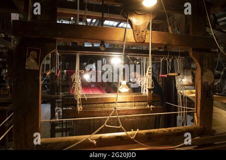 Traditional Bevilacqua weavers workshop, handycraft women work on more than 200 years old wooden loom weavings, in Venice since 1875 . Stock Photo