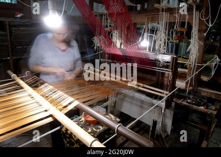 Traditional Bevilacqua weavers workshop, handycraft women work on more than 200 years old wooden loom weavings, in Venice since 1875 . Stock Photo